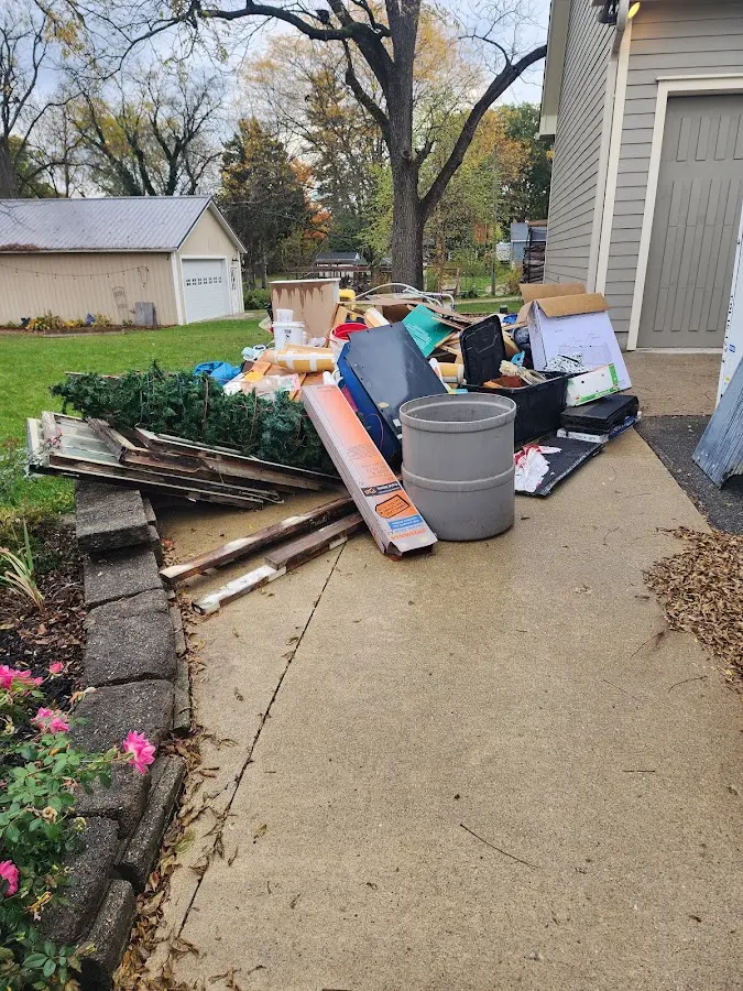 Dumpster being loaded with debris for Estate Cleanout Dumpster Rental in Walpole
